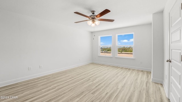 unfurnished bedroom with light wood finished floors, ceiling fan, and baseboards