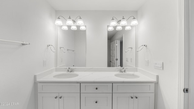 full bathroom featuring double vanity and a sink