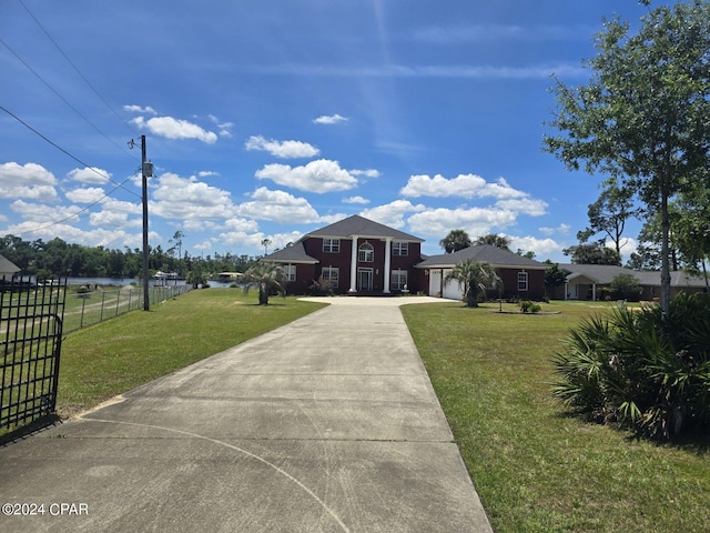 view of front of home featuring a garage, fence, a front lawn, and concrete driveway