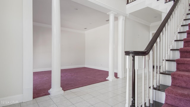 stairs featuring carpet flooring, baseboards, tile patterned floors, decorative columns, and crown molding