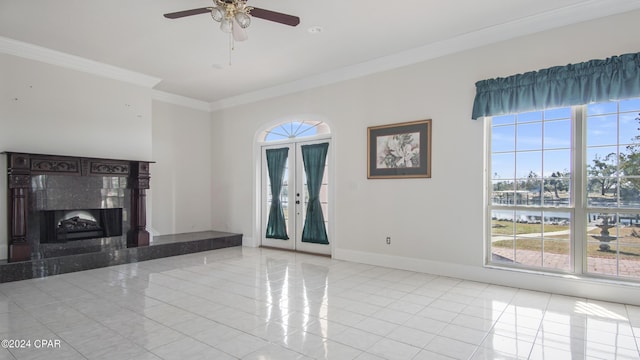 unfurnished living room featuring a high end fireplace, crown molding, baseboards, and light tile patterned floors