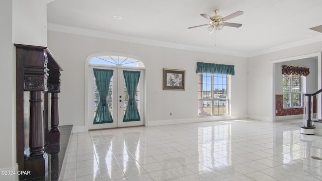 entrance foyer featuring baseboards, french doors, and crown molding