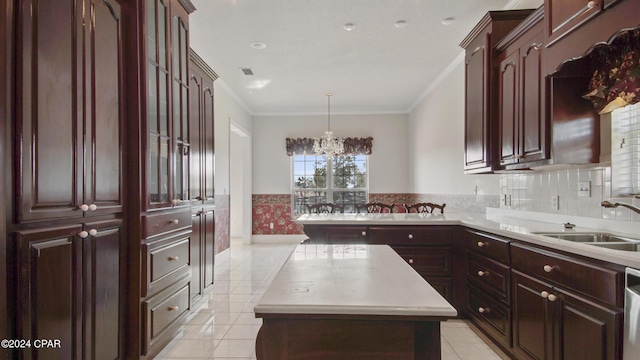 kitchen featuring light tile patterned floors, ornamental molding, a center island, light countertops, and a sink