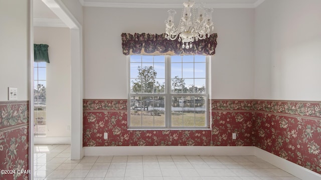 dining area featuring wallpapered walls, wainscoting, ornamental molding, tile patterned floors, and an inviting chandelier