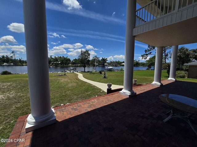 view of yard featuring a patio area and a water view