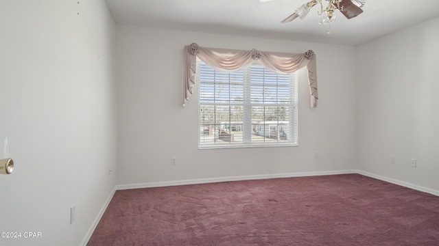 spare room with carpet floors, ceiling fan, and baseboards