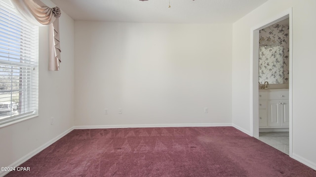 unfurnished room with ceiling fan, carpet flooring, and baseboards