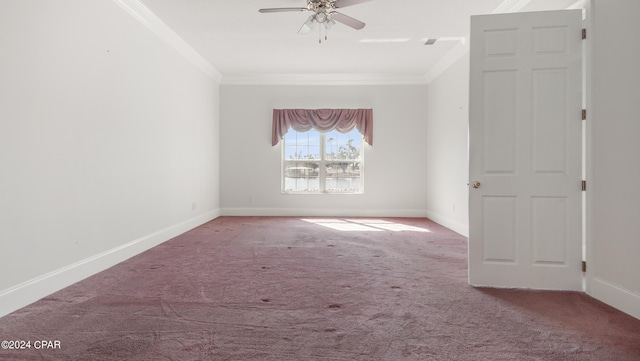 carpeted spare room with ceiling fan, ornamental molding, and baseboards