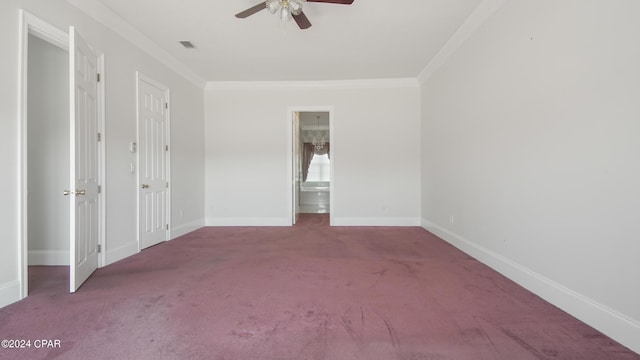 unfurnished bedroom featuring carpet, crown molding, visible vents, ensuite bathroom, and baseboards