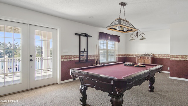 recreation room with wainscoting, pool table, carpet, a textured ceiling, and french doors