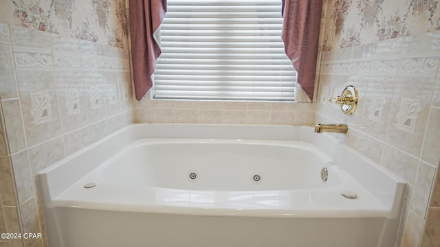 full bath featuring a whirlpool tub and tile walls