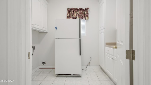 washroom with light tile patterned floors and baseboards