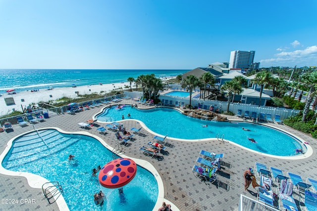 view of swimming pool featuring a patio area and a water view