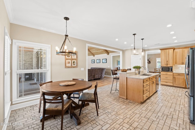 interior space featuring light hardwood / wood-style flooring, sink, a notable chandelier, and crown molding