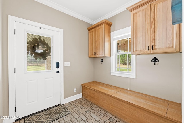 mudroom with a wealth of natural light, light tile floors, and ornamental molding