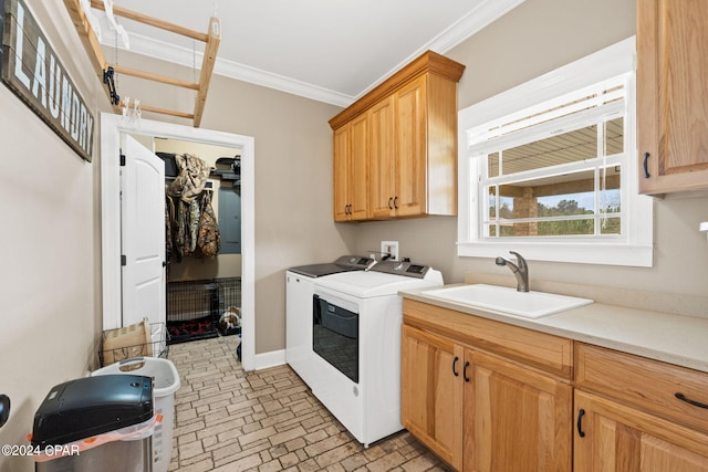 laundry area with washing machine and dryer, crown molding, washer hookup, sink, and cabinets