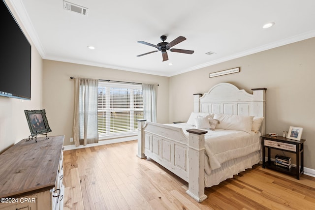 bedroom with light hardwood / wood-style flooring, ceiling fan, and crown molding