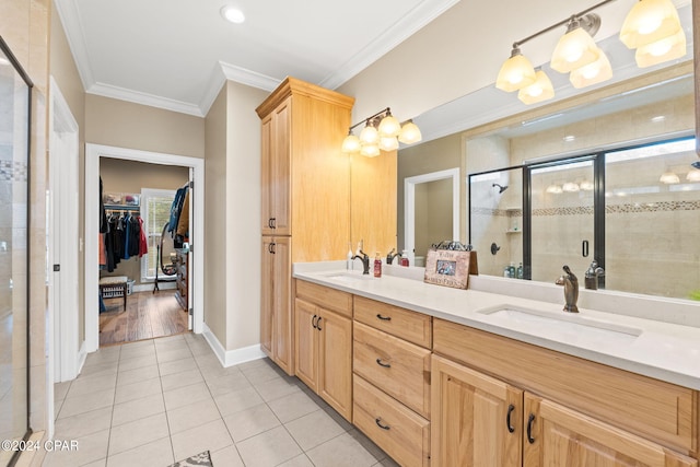 bathroom featuring crown molding, vanity with extensive cabinet space, tile flooring, an enclosed shower, and double sink