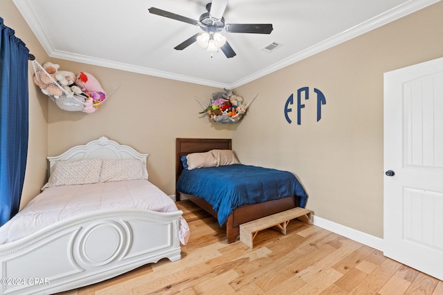 bedroom with ornamental molding, ceiling fan, and light wood-type flooring