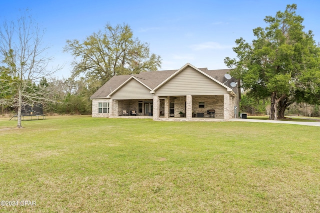 view of front facade with a front lawn and a trampoline