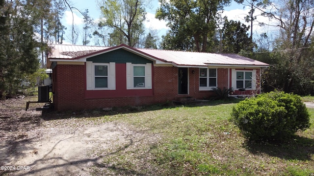 ranch-style home featuring a front lawn and central AC