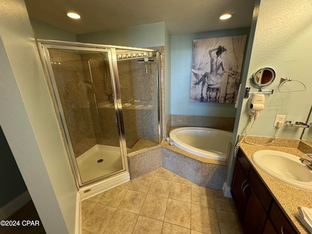 bathroom with tile patterned floors, independent shower and bath, and vanity