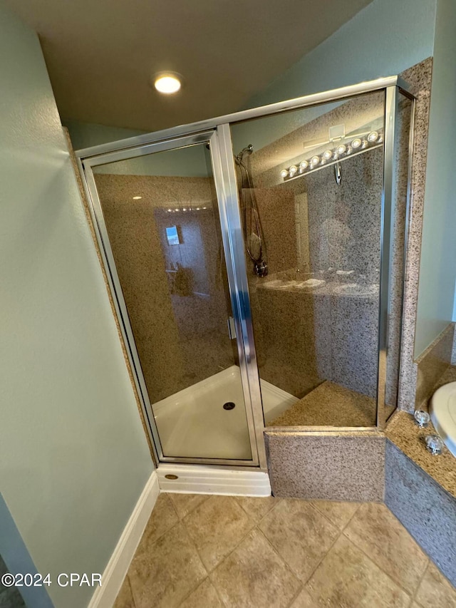 bathroom with independent shower and bath and tile patterned flooring