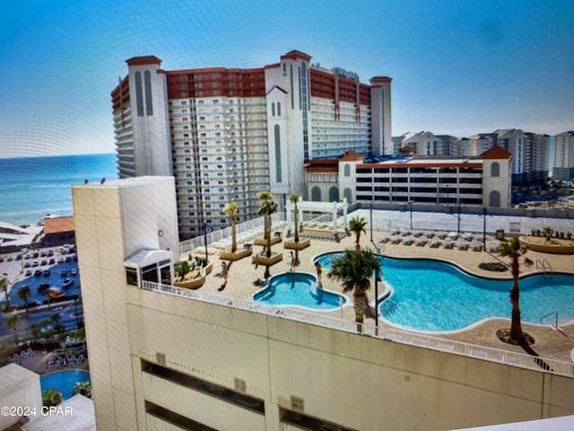 view of pool with a water view and a patio area