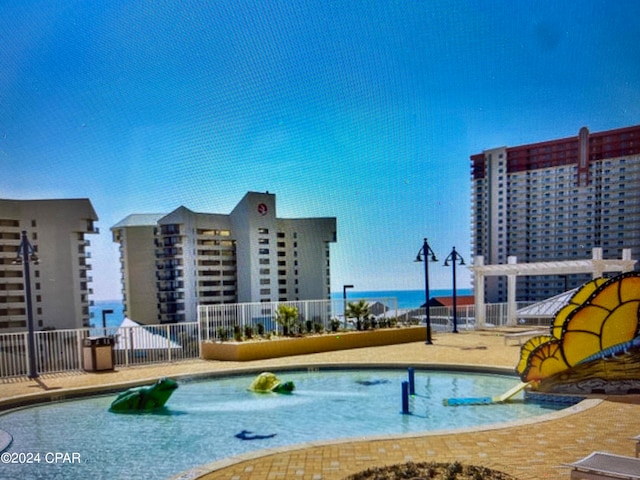 view of pool with a water view