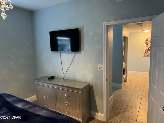 tiled bedroom featuring washer / dryer