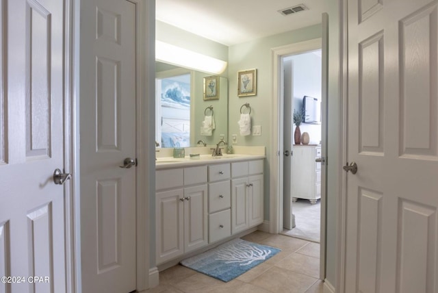 bathroom featuring tile patterned flooring and vanity