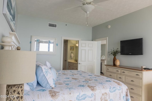 bedroom with connected bathroom, a textured ceiling, and ceiling fan