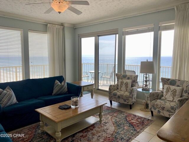 exterior space featuring a water view, a beach view, and a wealth of natural light