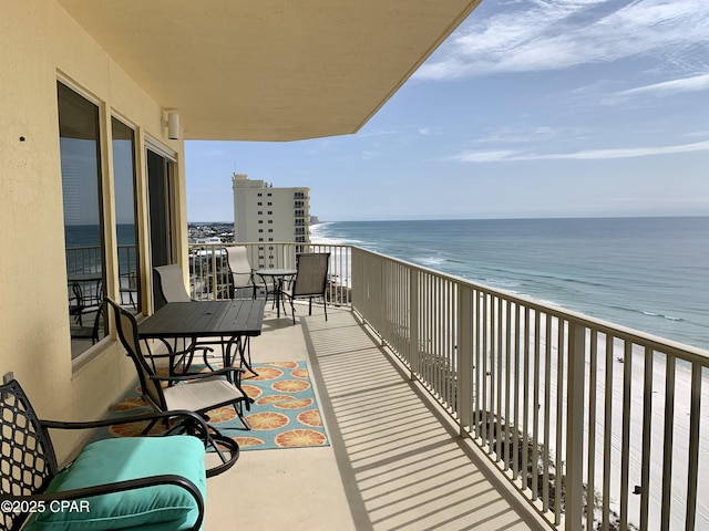 balcony with a view of the beach and a water view