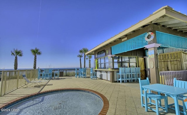 view of pool featuring a wooden deck and exterior bar