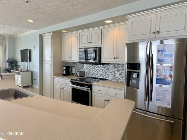 kitchen with sink, appliances with stainless steel finishes, tasteful backsplash, a textured ceiling, and white cabinets