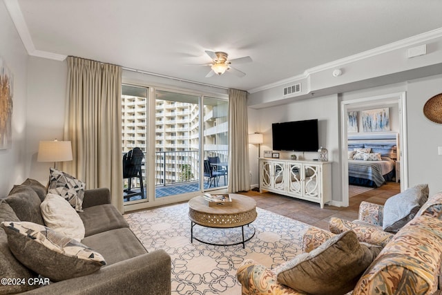 tiled living room with ceiling fan and ornamental molding