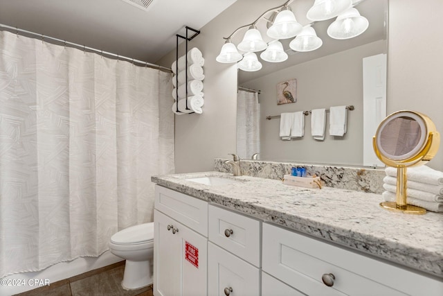 bathroom with toilet and oversized vanity