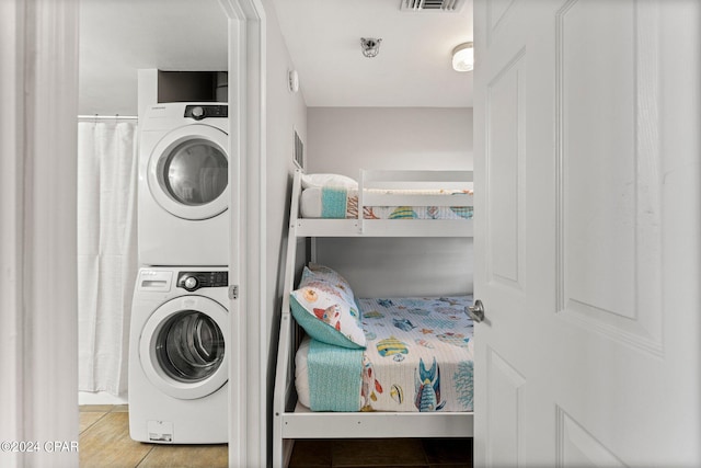 washroom featuring stacked washing maching and dryer