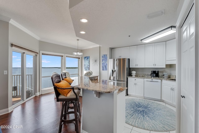 kitchen with stainless steel refrigerator with ice dispenser, white dishwasher, a textured ceiling, a water view, and white cabinets