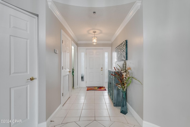 entrance foyer featuring crown molding, light tile patterned floors, and a textured ceiling