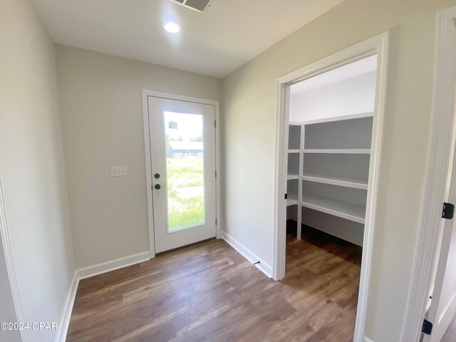 doorway to outside featuring recessed lighting, baseboards, and wood finished floors