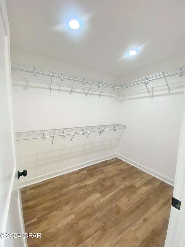 spacious closet with wood finished floors