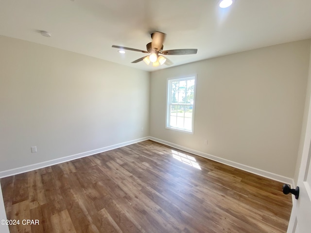 spare room featuring recessed lighting, ceiling fan, baseboards, and wood finished floors