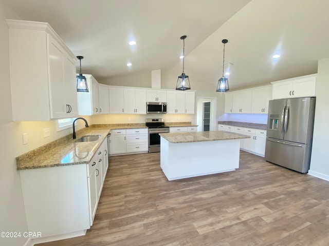 kitchen featuring stainless steel appliances, white cabinets, and a center island