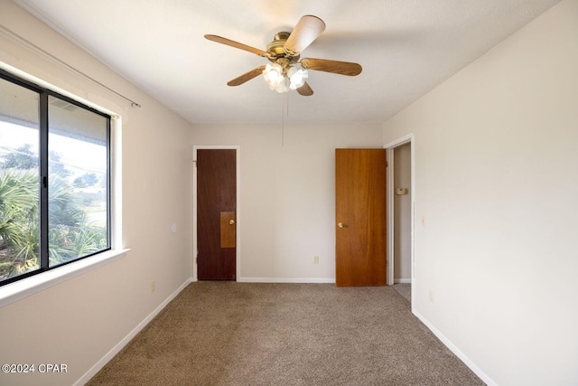 spare room with carpet flooring and ceiling fan