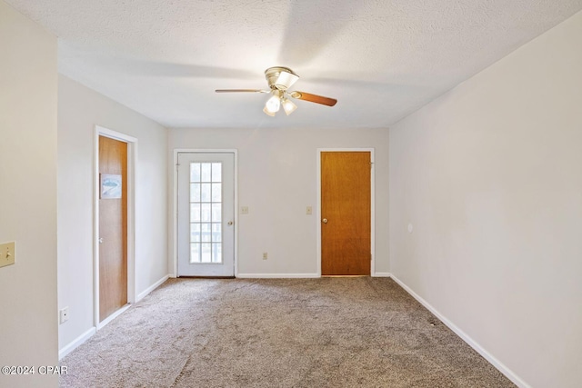 unfurnished room with carpet, a textured ceiling, and ceiling fan