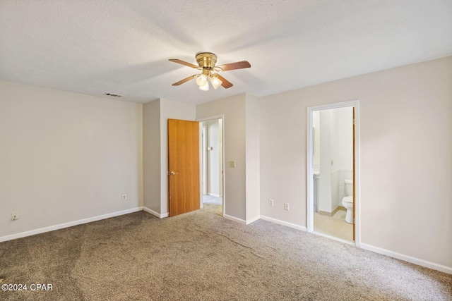 unfurnished bedroom with carpet, ensuite bathroom, a textured ceiling, and ceiling fan