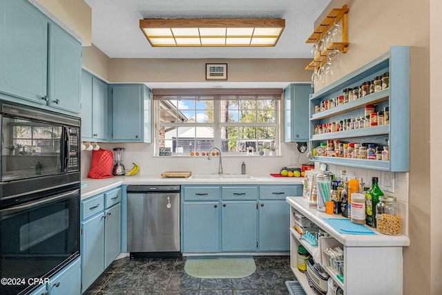 kitchen featuring backsplash, black appliances, dark tile floors, blue cabinets, and sink