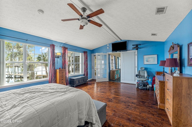 bedroom with ceiling fan, a textured ceiling, french doors, dark wood-type flooring, and lofted ceiling